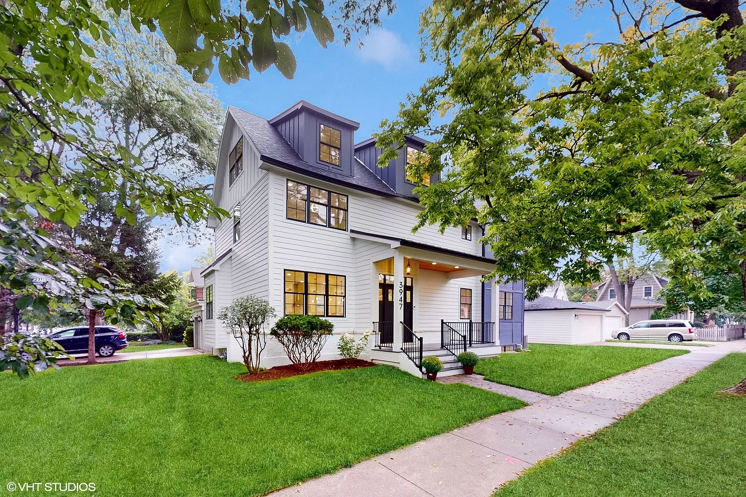 Front elevation of a completed custom home with landscaped yard